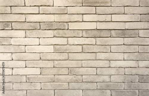 Wall of grey color clay brick texture in background