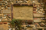 Empty textured brick frame in old flint stone wall background