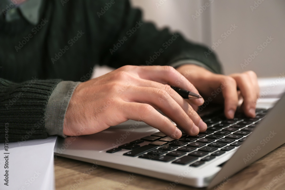 Young man using laptop for online learning at home, closeup Young man using laptop for online learning at home, closeup