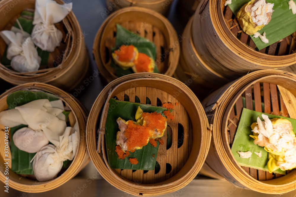 Variety of dim sum in bamboo basket. Chinese breakfast style in Southern of Thailand.