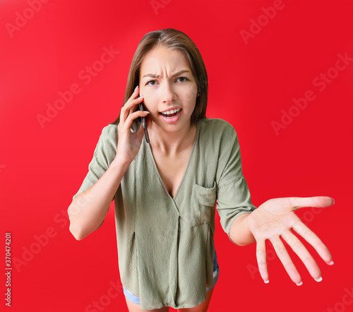 Indignant young woman talki...