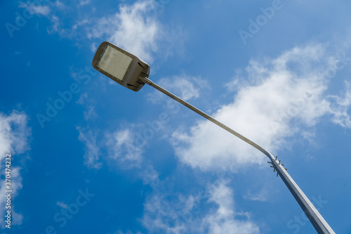 Street lantern on sky background.A modern street LED lighting pole