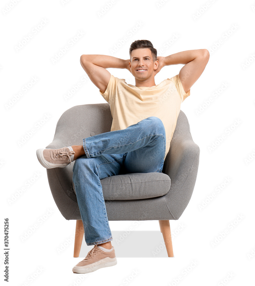 Young man relaxing in armchair on white background Young man relaxing in armchair on white background
