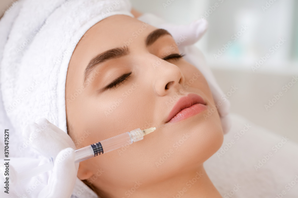 Young woman undergoing treatment in beauty salon Young woman undergoing treatment in beauty salon