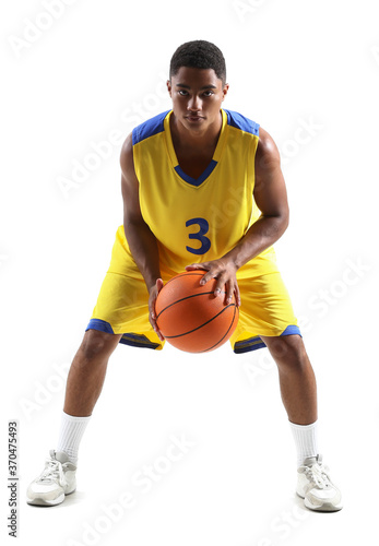 Young African-American basketball player on white background © Pixel-Shot