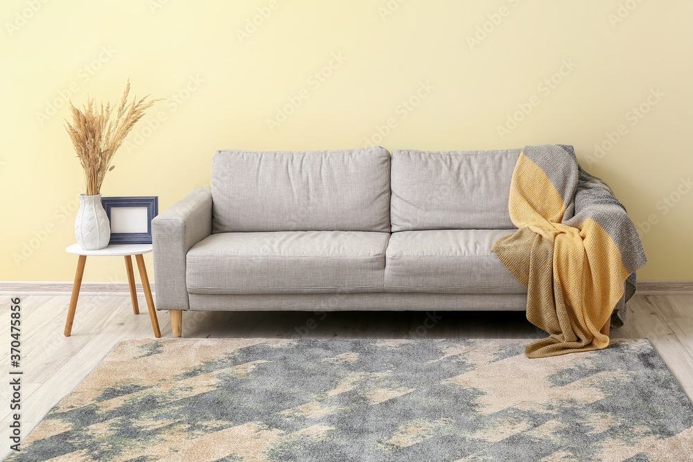 Interior of modern room with sofa and beautiful carpet - obrazy, fototapety, plakaty 