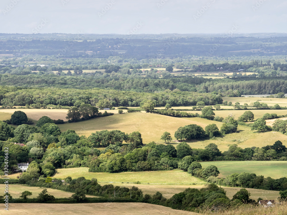 tunning vibrant landscape image of English countryside on lovely Summer afternoon overlooking rolling hills and country villages