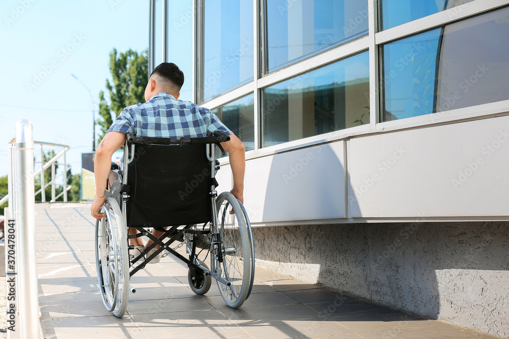 Young man in wheelchair on ramp outdoors Young man in wheelchair on ramp outdoors