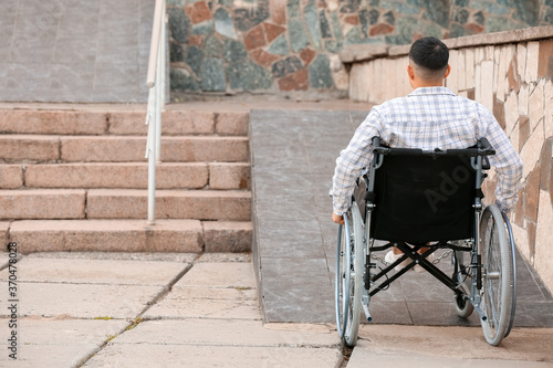 Young man in wheelchair nea...