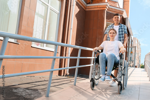 Young woman in wheelchair a...