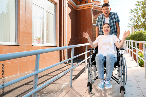 Young woman in wheelchair a...