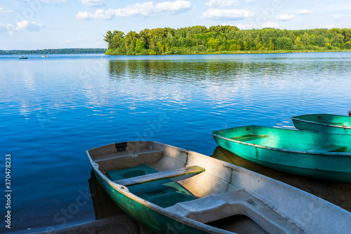 Fototapeta Naklejka Na Ścianę i Meble -  Old boats by the lake with a reflection on the water