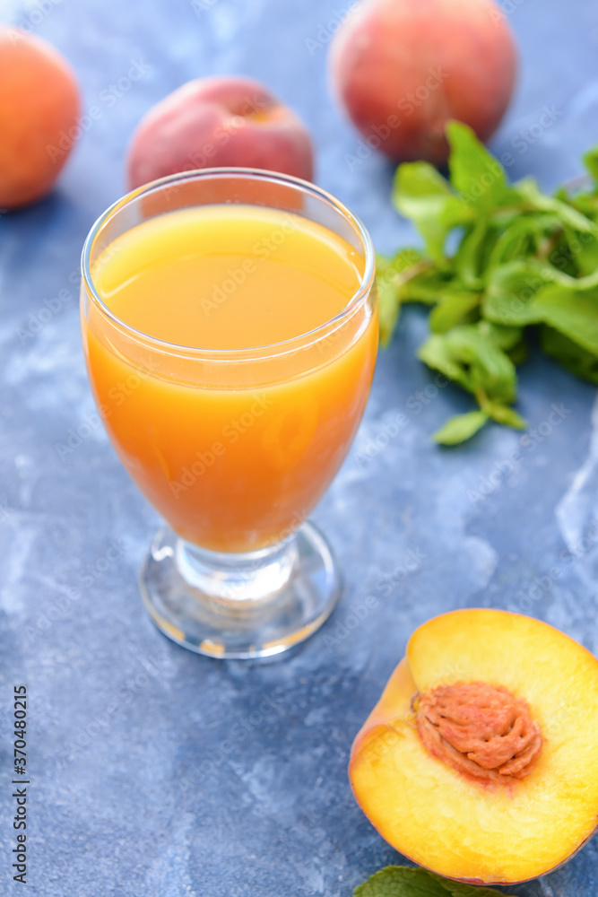 Glass of tasty peach juice on color background Glass of tasty peach juice on color background
