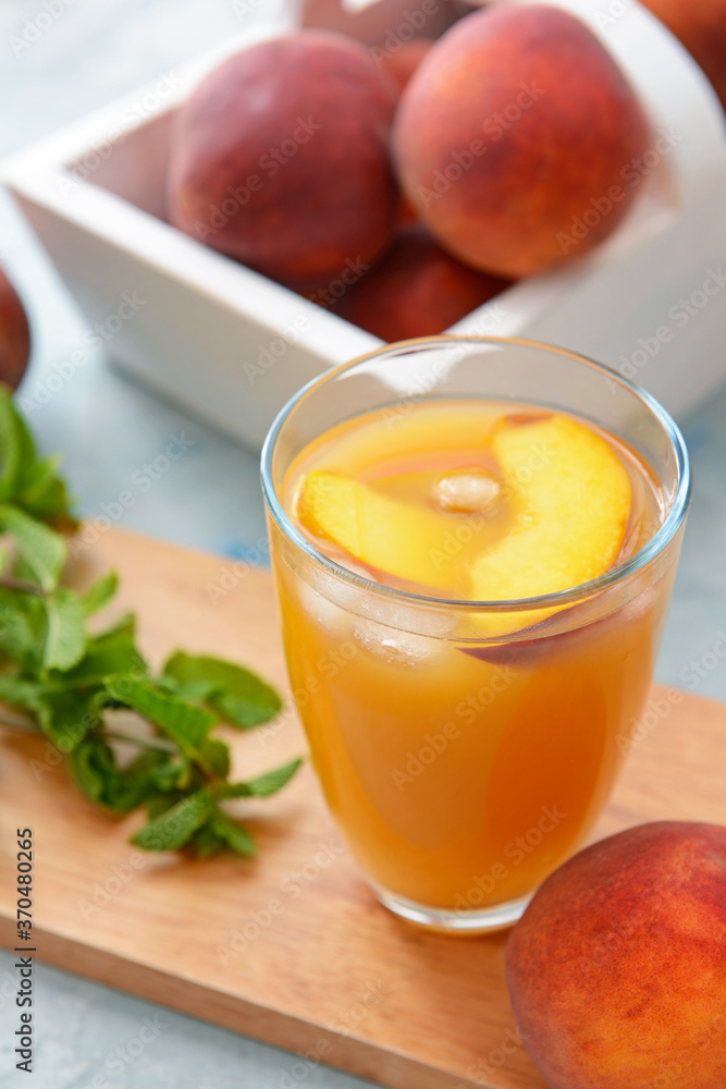 Glass of tasty peach juice on table Glass of tasty peach juice on table
