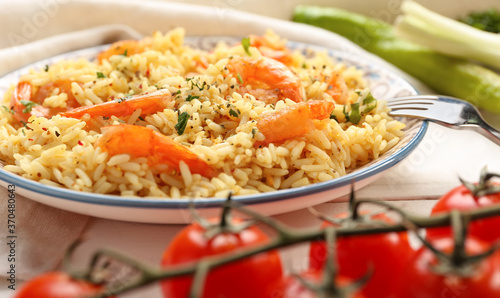 Plate with tasty pilaf on table, closeup