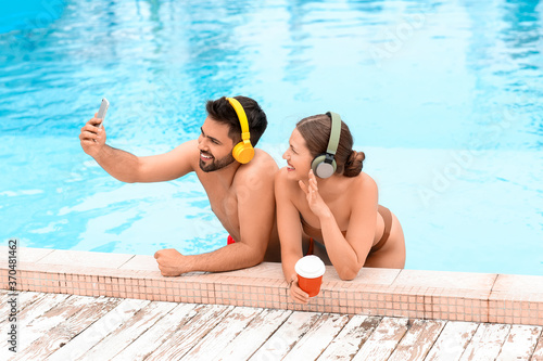 Young couple listening to m...