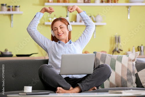 Woman with headphones worki...