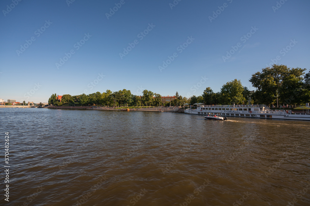 Obraz premium Wroclaw, Poland August 5, 2020; View of the city of Wroclaw from the perspective of the Odra River.