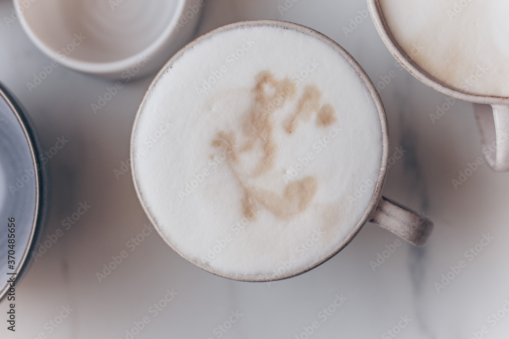 Top view of coffe Cappuccino cup on white marble background with copy space Top view of coffe Cappuccino cup on white marble background with copy space