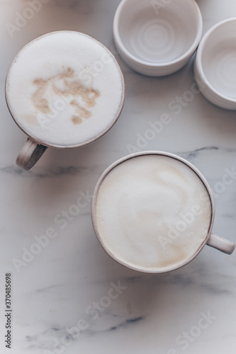 Top view of coffe Cappuccino cup on white marble background with copy space