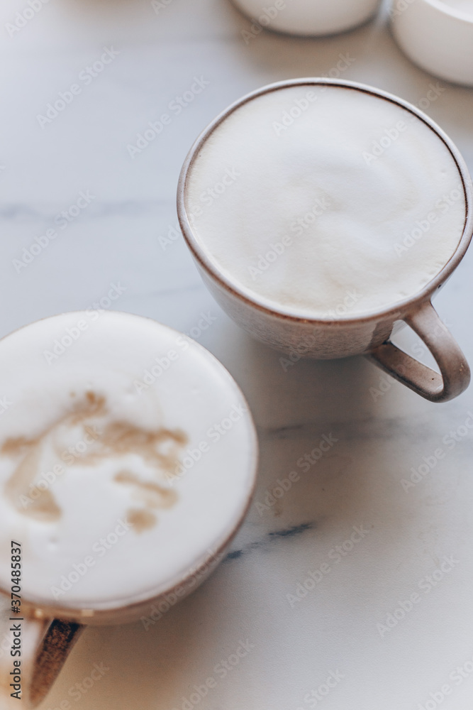 Top view of coffe Cappuccino cup on white marble background with copy space Top view of coffe Cappuccino cup on white marble background with copy space
