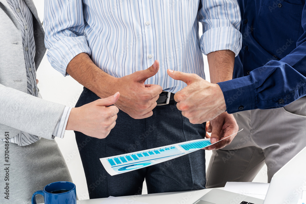 Group of business people showing thumbs up Group of business people showing thumbs up