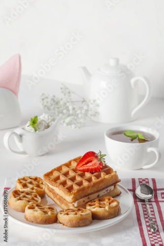 Wallpaper Mural Breakfast. Fresh waffles on a white plate with strawberries and mint leaves on a white table. Fresh cottage cheese in a tea set. Torontodigital.ca
