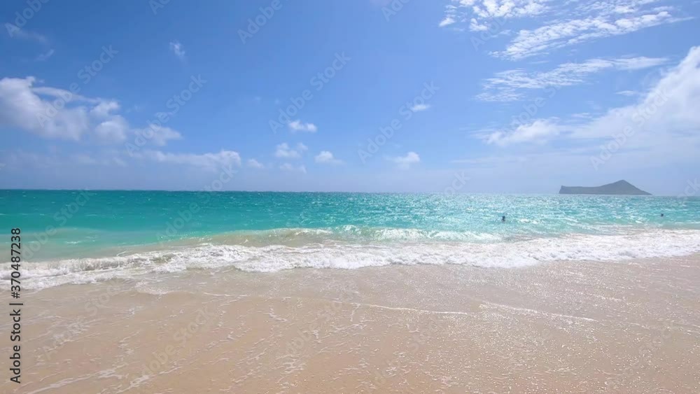 Beautiful crystal blue sea foamy waves splashing at sandy beach at Hawaiian island Oahu. Beautiful crystal blue sea foamy waves splashing at sandy beach at Hawaiian island Oahu.
