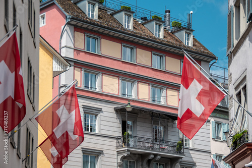 Street decorated with Swiss flags. Narrow street in center of Zurich  Switzerland