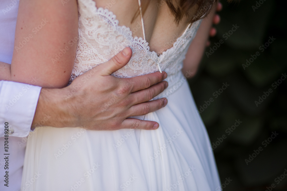 groom with bride in wedding dress in summer park groom with bride in wedding dress in summer park