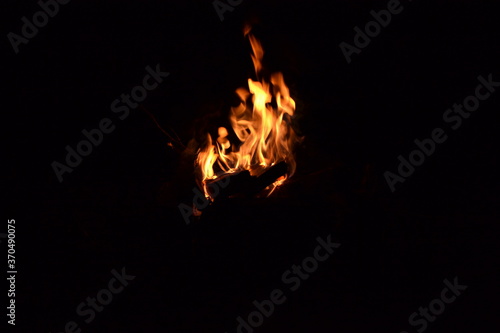 Beautiful dark photo with a burning bonfire © kirill_phr