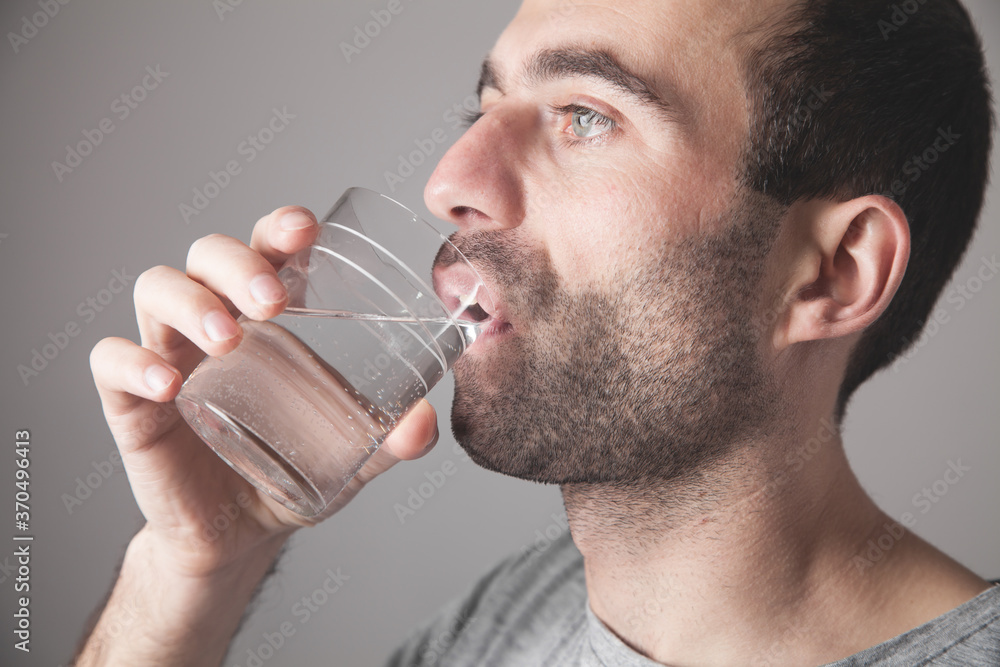 Caucasian man drinking fresh water. Caucasian man drinking fresh water.