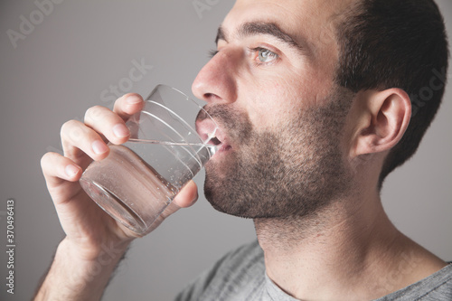 Caucasian man drinking fresh water.