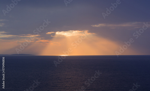 The sun shines through the cloud at sunset.Beautiful landscape