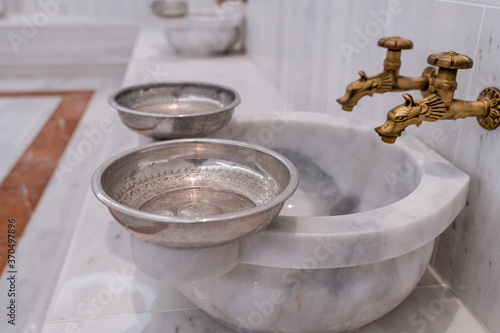 Photos Traditional Turkish bath hammam or hamam with marble benches and sinks, taps for