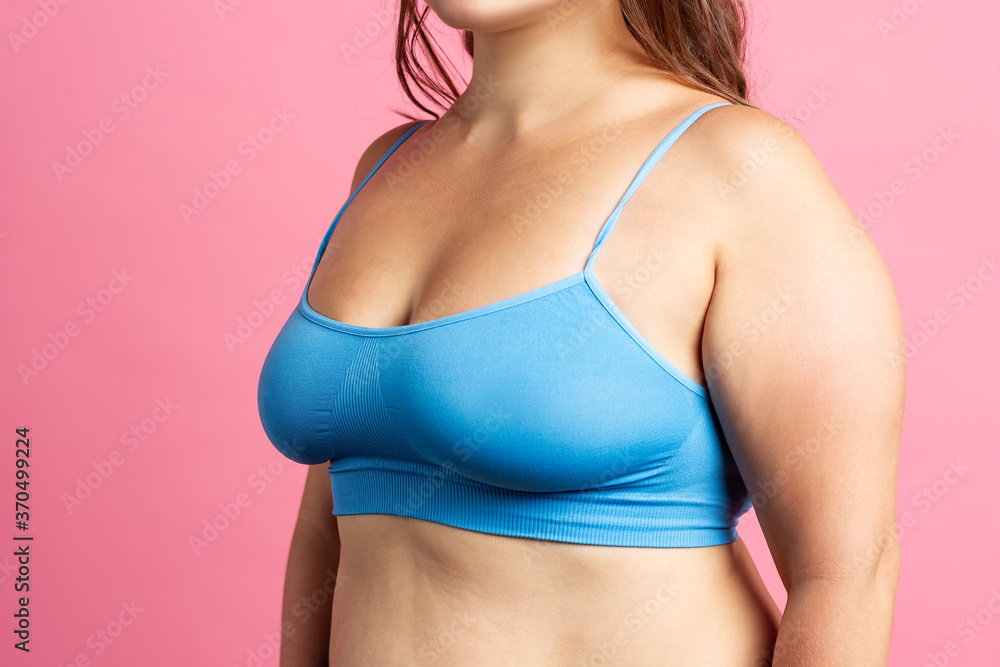 Woman in blue bra on pink background Woman in blue bra on pink background