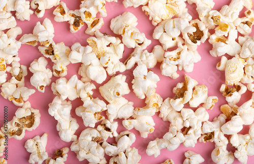 Popcorn on Pink Background. Snack when watching a movie. Flat lay with copy space. Full. Cinema and entertainment concept. Pattern Template