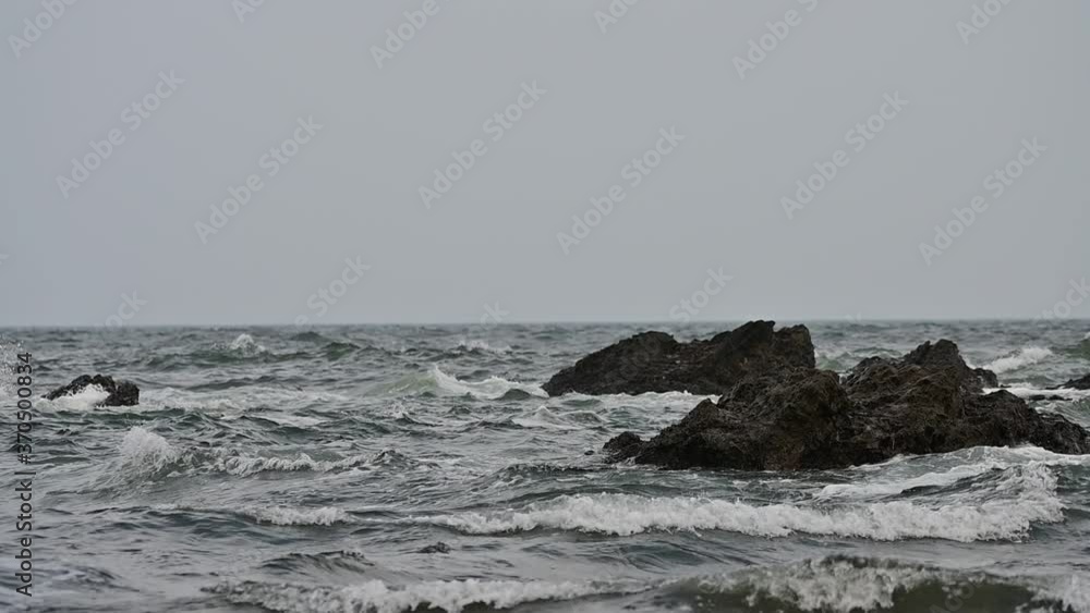 Waves, Rock, and cloudy day in ocean horizon Waves, Rock, and cloudy day in ocean horizon