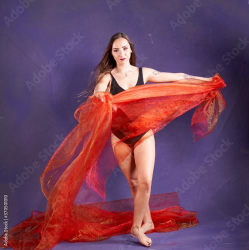 a white nice and fit girl, dancing with orange sash.