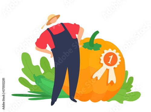 Giant vegetables championship winner. Champion of the tournament holds the best big pumpkin. First place medal. A proud gardener. photo