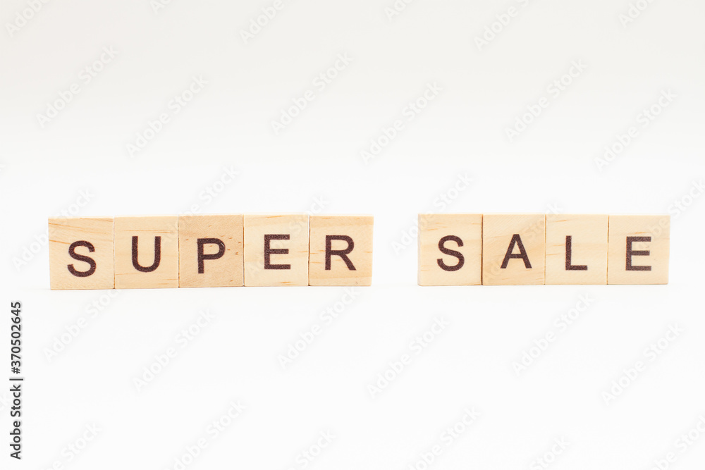 Word SUPER SALE made of wooden blocks on white background Word SUPER SALE made of wooden blocks on white background