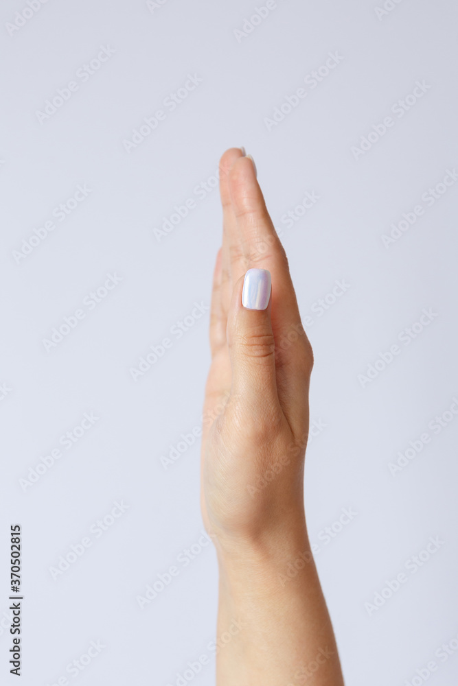 Naklejka premium Gesture and symbol. The hand is holding or squeezing something in between