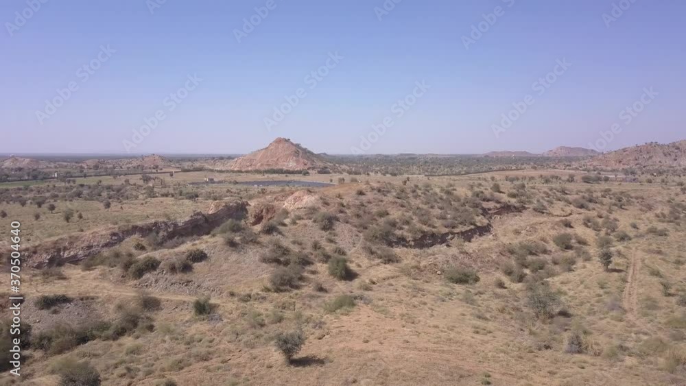 Vibrant Sunlight On The Dry Land Surface In Rajasthan, India Under The Clear Blue Sky - arc shot Vibrant Sunlight On The Dry Land Surface In Rajasthan, India Under The Clear Blue Sky - arc shot