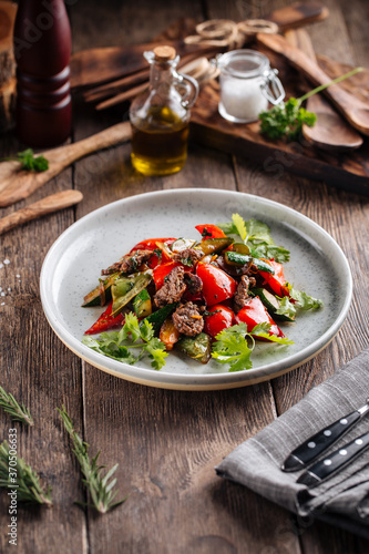 Warm salad with beef and vegetables on a plate