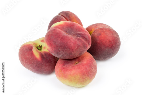 Pile of flat and ordinary peaches on a white background