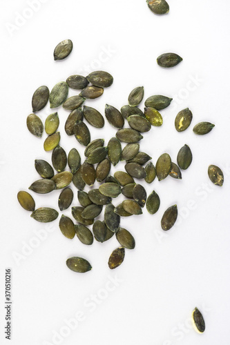 Pumpkin seeds on white background with copy space