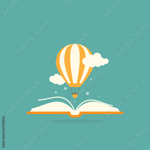 Open book with air balloon and clouds. isolated on turquoise background.