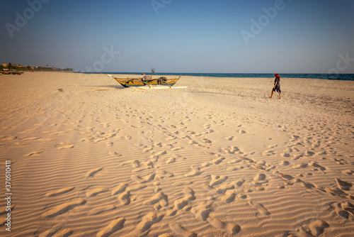 Woman walks along sandy beach of the Indian Ocean coast  travels to Southeast Asia Sri Lanka island