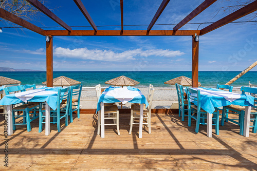 Empty restaurant tables at the Maleme beach on Crete  Greece