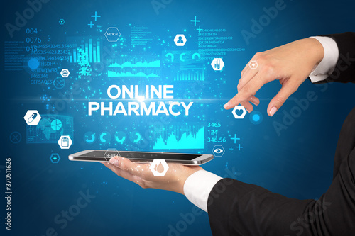 Close-up of a touchscreen with ONLINE PHARMACY inscription, medical concept